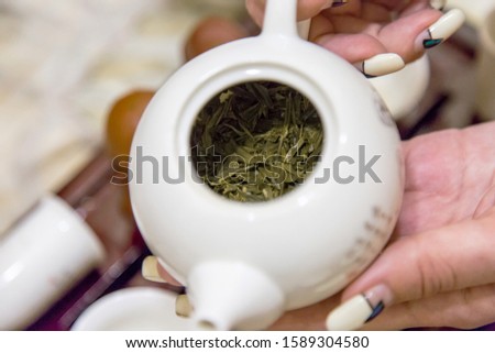 Chinese tea ceremony with green tea and a set of dishes