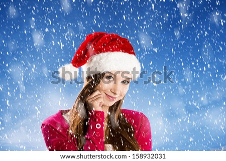 Beautiful woman with christmas hat in winter nature