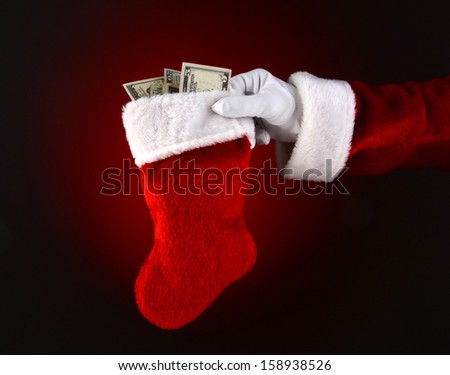 Closeup of Santa Claus holding a stocking full of cash. 