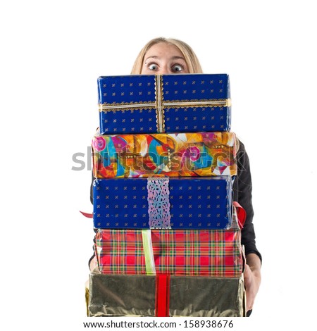 Young woman / girl  with big eyes holding a stack of present boxes