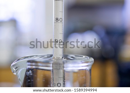 Reading the value from a hydrometer. Used for determining the specific gravity of liquids including beer. 