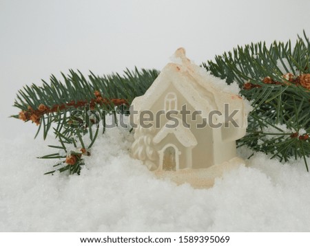 Christmas tree toy on the background of artificial snow and green pine branches  