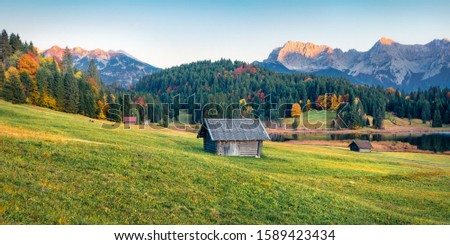 Panoramic evening view of Wagenbruchsee (Geroldsee) lake with Westliche Karwendelspitze mountain range on background. Amazing autumn scene of Bavarian Alps, Germany, Europe. 