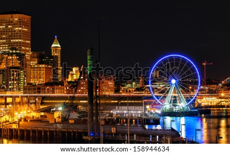 Seattle waterfront and skyline illuminated at night. Copy space
