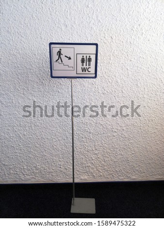 Signboard with wc toilet sign down on white background