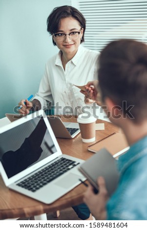 Happy woman holding a note from male employer stock photo