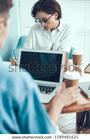 Employees working diligently at the table stock photo