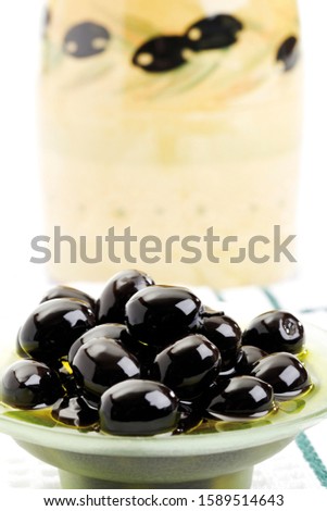 Black olives in a small glass bowl