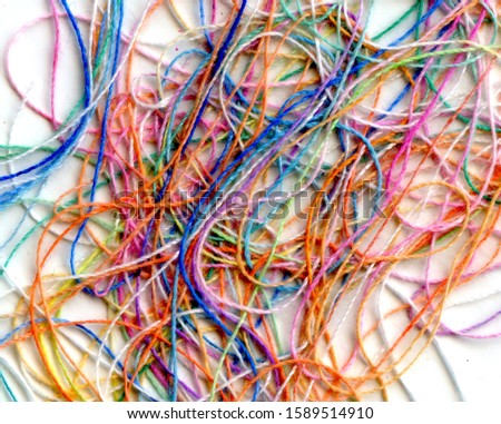 Multicolor tangled color needlecraft silk cord. Abstract color background, in white background