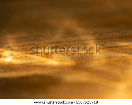 blurry of sunlight shined through water in bottle on wood floor, backgroung concept on photography image.