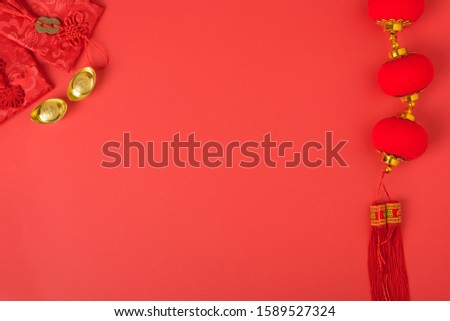 Chinese new year concept, flat lay top view, Happy Chinese new year with Red envelope and gold ingot (Character "FU" means fortune, blessing, wealth) on red background with copy space for your text