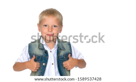 A little boy is holding a finger up.