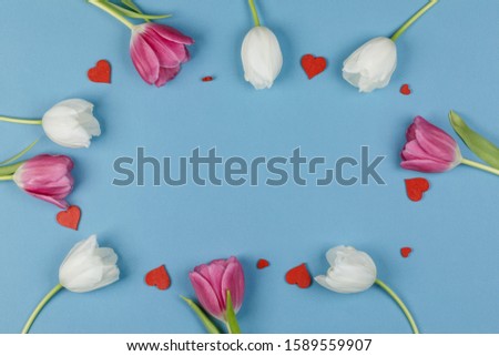 Frame made of colourful tulips and red hearts Valentines day background
