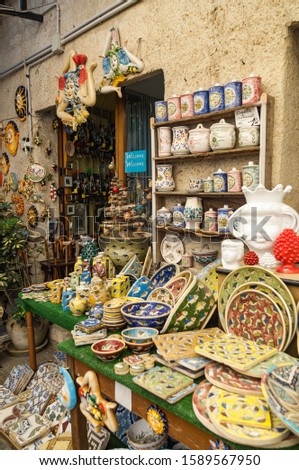 Photo typical Sicilian souvenir ceramics on the background of the wall of the store. Sicily, Erice. Royalty-Free Stock Photo #1589567950