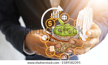 business man and strategy plan cartoon with the plant in the Glass bottles in business startup concept with Warm light Composition and white background, Business growth in leader hand.
