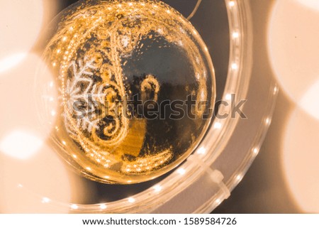 Christmas decorations in yellow and orange shades. Reflection.