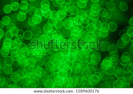 Classic bokeh “soap bubbles” light green. Festive Christmas elegant abstract background with booble bokeh lights. Background with defocused lights. Copy space.