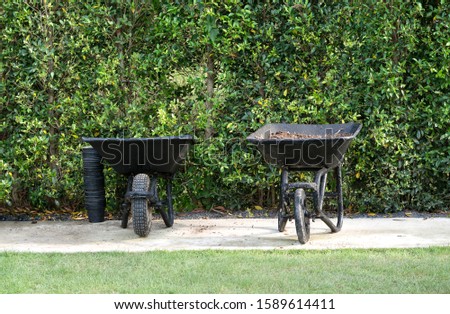 wheelbarrow filled with soil in a garden
