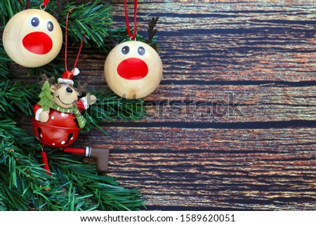 Branches of spruce and Christmas tree toys on  a wooden background. Concept of new year, winter holidays.