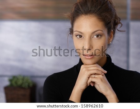 Portrait of beautiful businesswoman looking at camera.