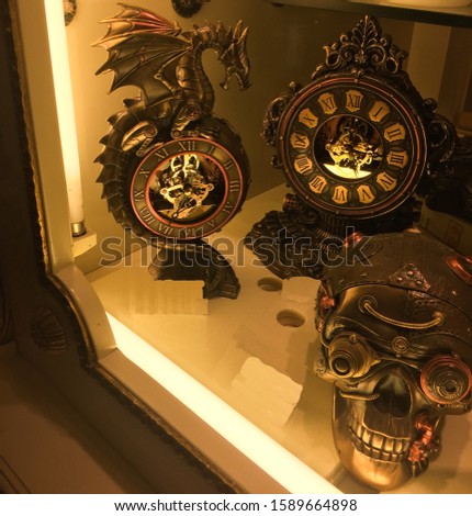 Antique and unique dark brown clock collection includes dragon clock, skull sculpture at the shop of venice. Particularly focused on the dragon clock.