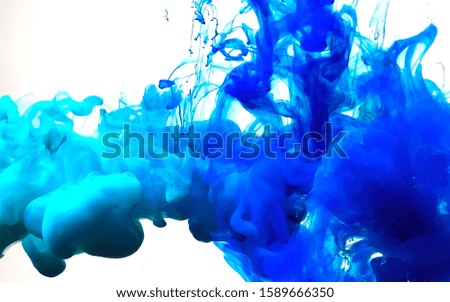 Blue magic abstract background. Stylish modern background. Watercolor ink in water. Powerful explosion of paints on a white background. Cool trending screensaver.

