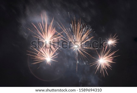 White coloured fireworks at a dark sky