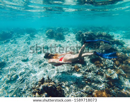 Travel girl practicing extreme active scuba sport for feeling admire from tropical ocean with breathtaking coral reef, recreation summer holidays for discover sea depths and aquatic underwater life