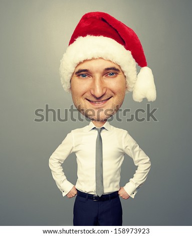 smiley bighead man in santa hat over grey background