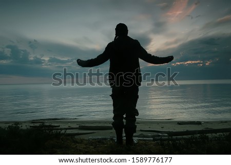 man traveler by the lake, silhouette of a man on a campaign, activity