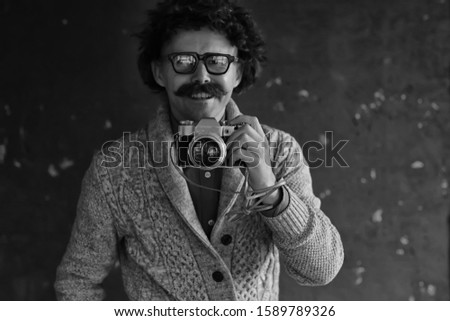 photographer with a vintage analog camera, a man with mustache, funny image learning photography