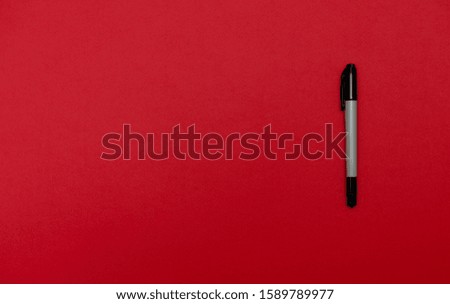 Marker on blank colored textured paper. Place for text. Top view. Background for presentation.