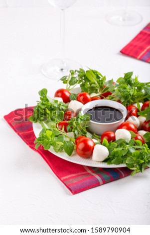 Caprese skewers with balsamic glaze, caprese salad Christmas wreath. Delicious appetizer, finger food.