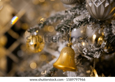 Christmas tree decorated with toys in traditional  gold color, luminous Christmas garland