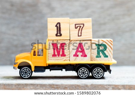 Truck hold letter block in word 17mar on wood background (Concept for date 17 month March)