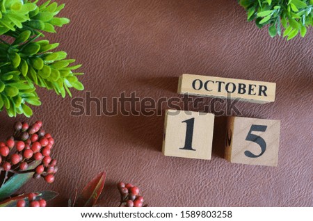 October 15. Number cube in natural concept on leather for the background