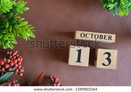 October 13. Number cube in natural concept on leather for the background
