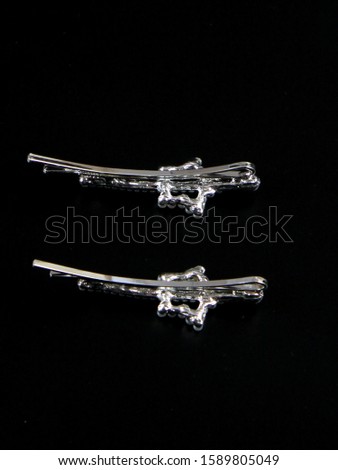 set of hair accessories pins on silk black background. Beauty concept