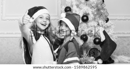 Family holiday tradition. Children cheerful celebrate christmas. Kids christmas costumes santa and elf. Winter masquerade concept. Siblings ready celebrate christmas or meet new year. Merry christmas.