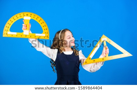 Smart and clever concept. Girl with big ruler. School student study geometry. Kid school uniform hold ruler. School education concept. Sizing and measuring. Learn mathematics. Theorems and axioms.