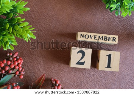 November 21. Number cube in natural concept on leather for the background