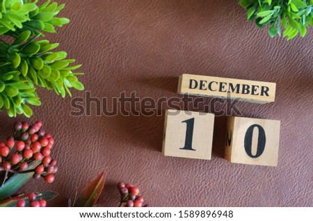 December 10. Number cube in natural concept on leather for the background
