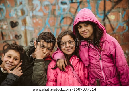Portrait of happy Roma children in the neighborhood Royalty-Free Stock Photo #1589897314