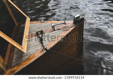 Pleasure boat moored by a water rope