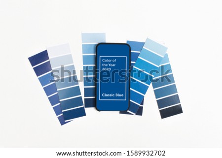Color swatches and smartphone with color of the year 2020 - Classic Blue. Color trend palette. Top view, flat lay. 