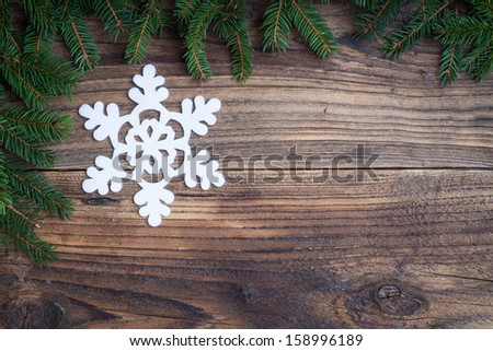Christmas snowflake on old wooden background