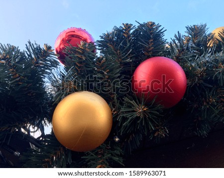 Christmas flasks on spruce twigs against the sky