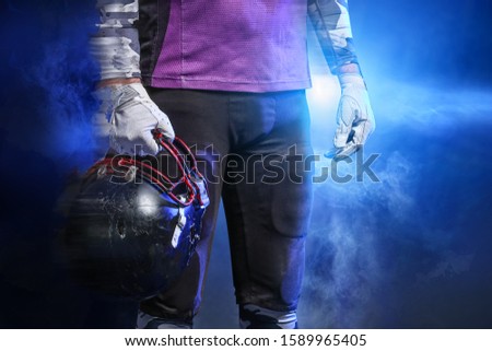American football player in smoke on dark background