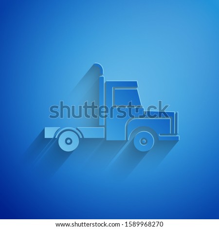 Paper cut Delivery cargo truck vehicle icon isolated on blue background. Paper art style. 