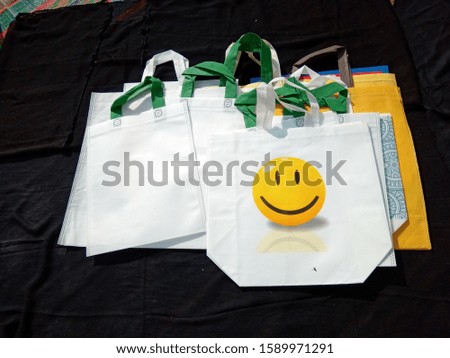 White color eco friendly bags lying on black background , non woven 